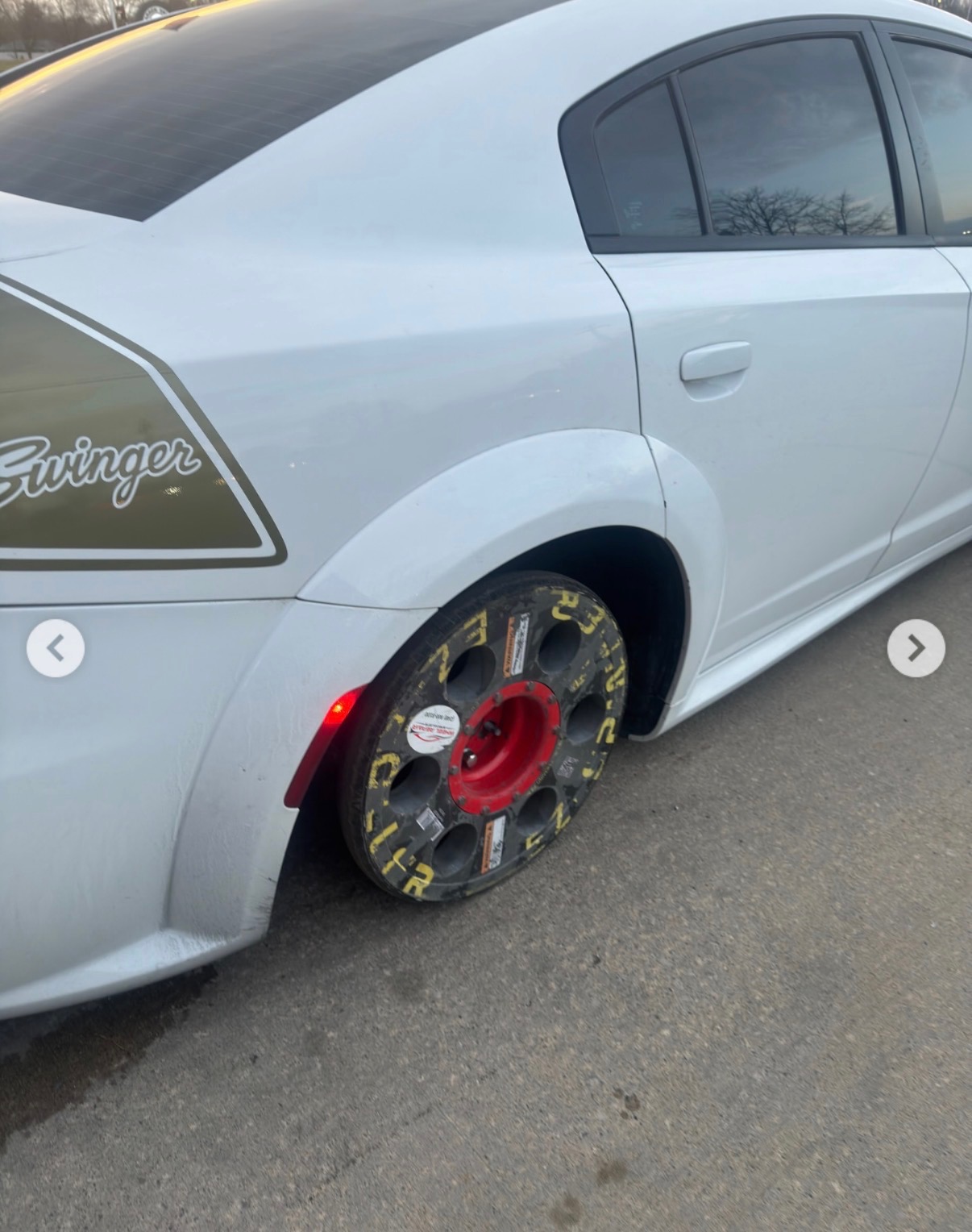 Dodge Charger Swinger with damaged wheel and fender before repair